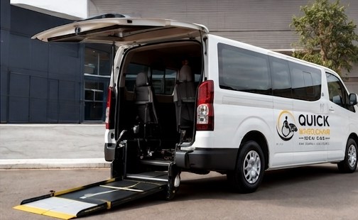 Wheelchair user being assisted into an accessible vehicle